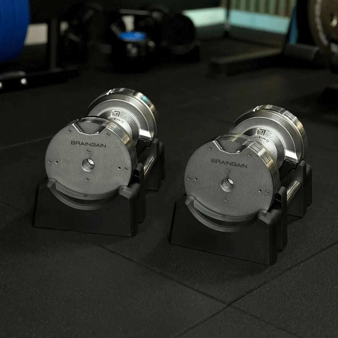 Close-up of BRAINGAIN 41.5kg chrome adjustable dumbbell on storage base with knurled grip handle