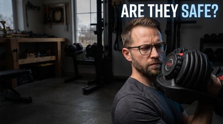 Engineer Nathan Cole inspecting the dial locking mechanism of an adjustable dumbbell, with the caption Are they safe
