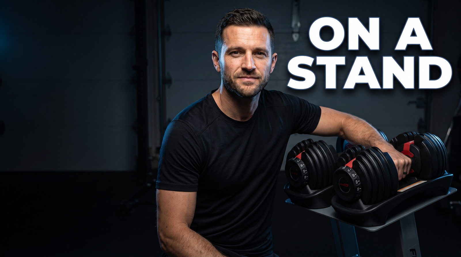 Chris Whelan resting his arm on adjustable dumbbells sitting on a waist-height stand, with the caption On a stand
